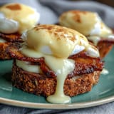 Classic Eggs Benedict with Hollandaise sauce, poached eggs, Canadian bacon, and toasted English muffins, perfect for a brunch feast.