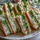 Bright lemon butter tea sandwiches with fresh cucumber and herbs, perfect for a festive Mothers Day brunch.