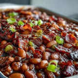 Rich molasses and bacon perfume these slow-cooked Juneteenth BBQ Baked Beans.
