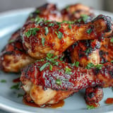 Juicy BBQ Chicken Drumsticks with Spicy Peach Glaze, perfectly grilled and glistening.