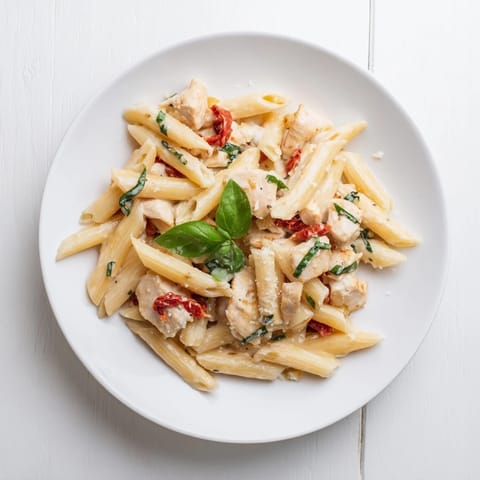 Fork-ready Creamy Sun-Dried Tomato Chicken Pasta shines with juicy chicken strips and vibrant sun-dried tomatoes in a luscious sauce.
