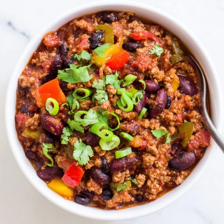 Hearty Turkey Chili in a rustic bowl, ready to serve with lime wedges, perfect for a cozy family dinner.