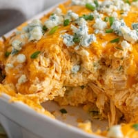 Golden, bubbly Buffalo Chicken Dip fresh from the oven with a spicy orange hue. 